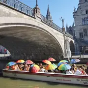 Tourists with umbrellas on a boat tour