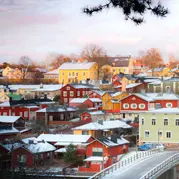 A snowy village with colourful buildings