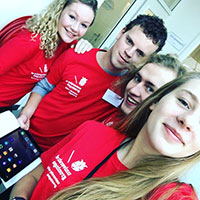 Four students dressed in University College Groningen clothing