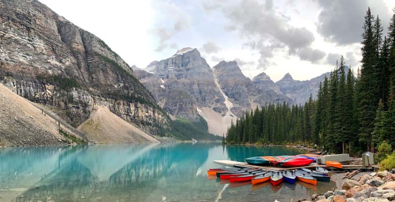 Canoes on a rocky shore in Lake Louise, Canada