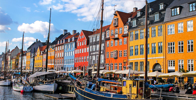 Colourful houses next to boats in Copenhagen, Denmark