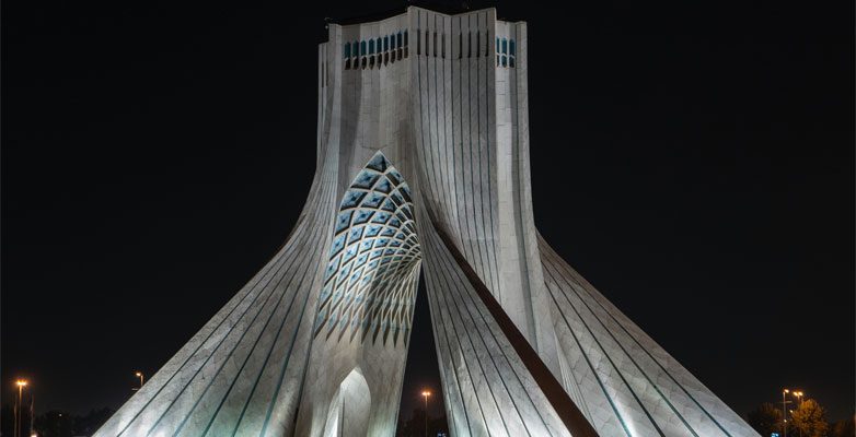 The Azadi Tower shown here lit up at night, is located in Tehran, Iran