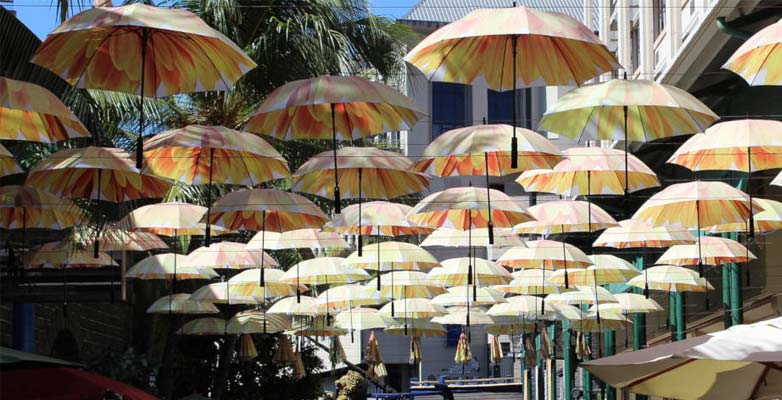 A street lined with colourful umbrellas in Port Louis, Mauritius