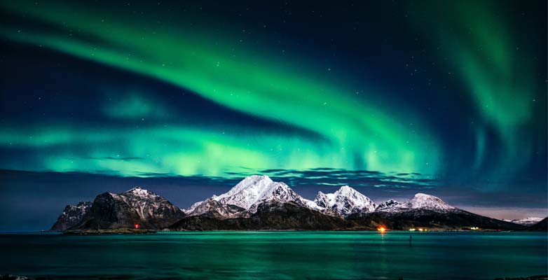 The Aurora Borealis above a mountain range in Norway
