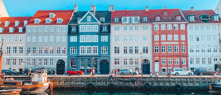 Picture of a row of colourful houses next to a body of water
