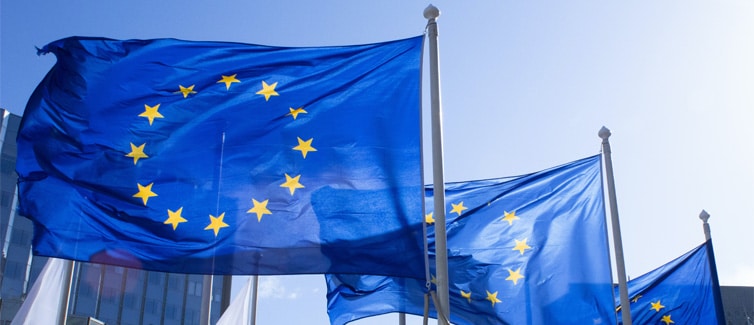 Image of three European Union flags flying on flagpoles