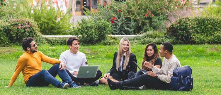 Students sitting in a group on grass