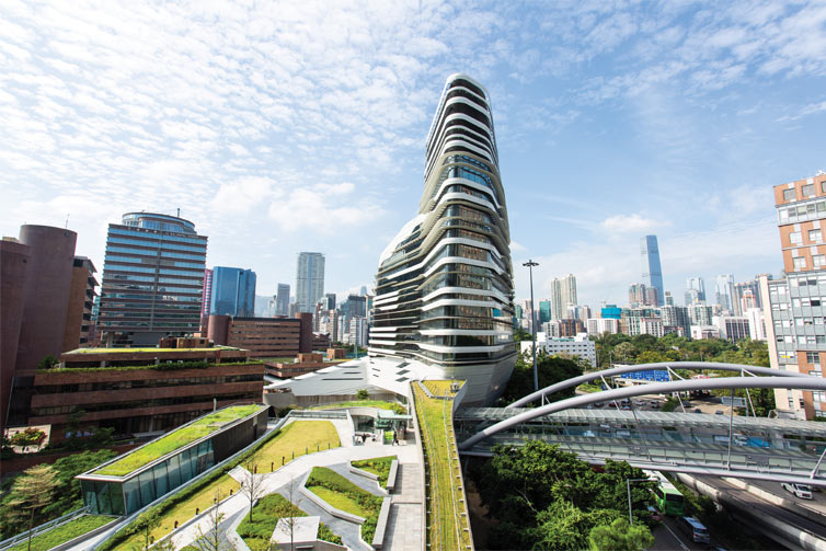Image of a tall tower building in front of a skyline full of tall buildings
