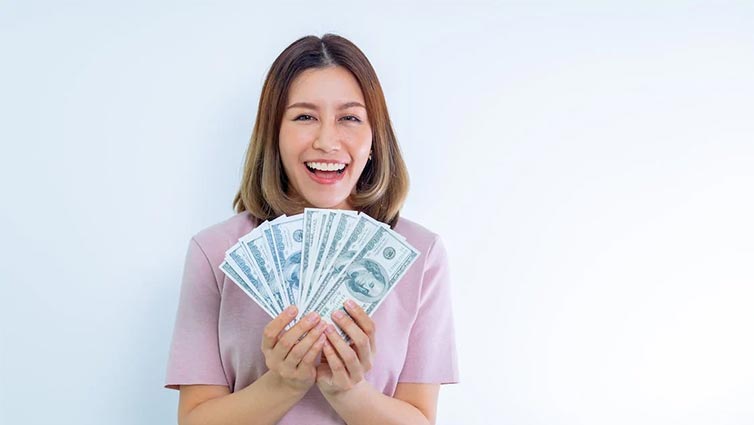 Lady smiling holding cash