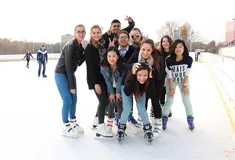 Smiling students skating on ice