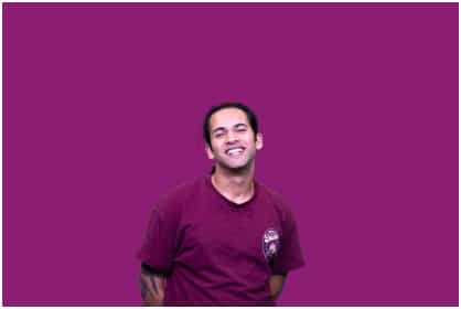 Image of a student wearing a purple t-shirt with a purple background