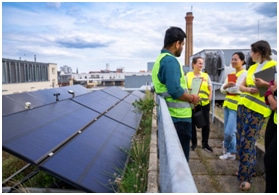 Image of students wearing hi-vis vests looking at photovoltaic panels