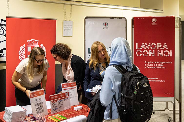 People standing around a table talking