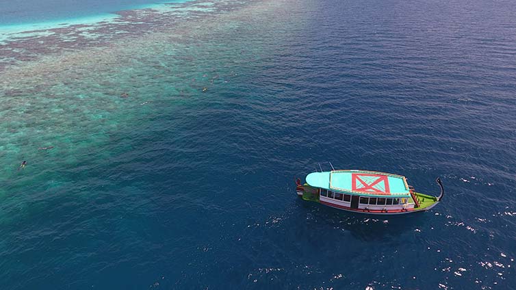 A boat sailing on clear blue water